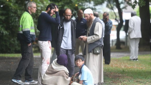 Stunned and bloodied workshippers outside one of the Christchurch mosques.