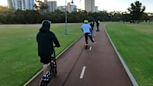 Kids riding e-scooters in Queensland