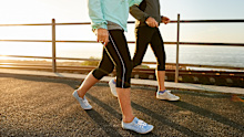 two senior women walking together in morning