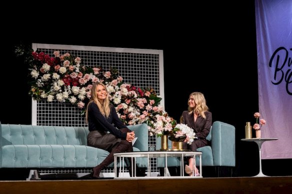 Australian model Elle Macpherson with host Emma Vosti on stage at a Business Chicks event in Melbourne in 2019.