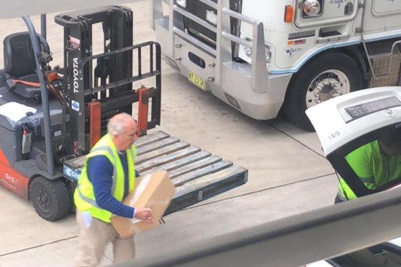 Mark De Hesselle is captured on CCTV removing a box of banana pulp from a freezer storage unit in 2020.