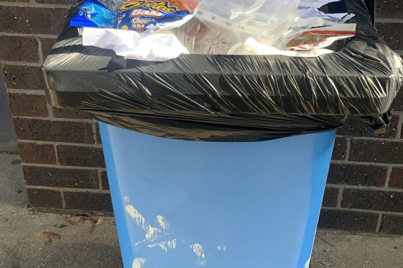 A full rubbish bin at a Victorian school. Principals say bins are often not emptied, while cleaners say they don’t get enough time at schools.