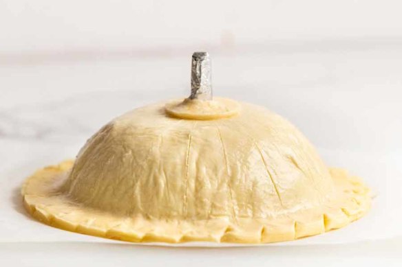 The pithivier is now ready to be baked. (The chimney tube keeps the gravy hole open as the pithivier bakes.)