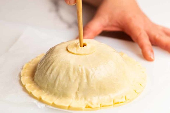 Step 6. Cut a small round of pastry for the chimney hole ring. Brush with egg white then place in the centre of the dome. Use a chopstick to pierce a hole in the pastry.