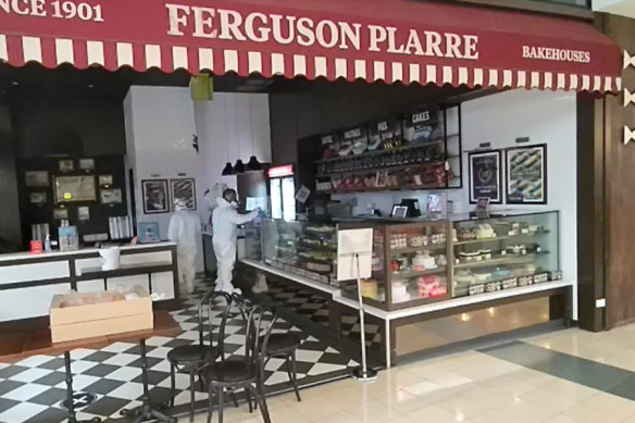 People in hazmat suits give the Ferguson Plarre bakery at the Chadstone shopping centre a deep clean after an employee who worked in the store on Wednesday tested positive for COVID-19. 