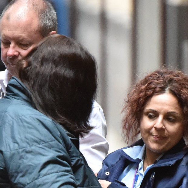 Katia Pyliotis, her face hidden by her hair, arrives at the Supreme Court in Melbourne in April 2019.