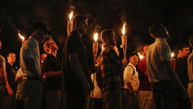 Multiple white nationalist groups march with torches through the University of Virginia.