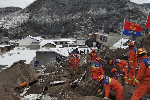 Rescue workers deal with the aftermath of a landslide in Yunnan Province, China.