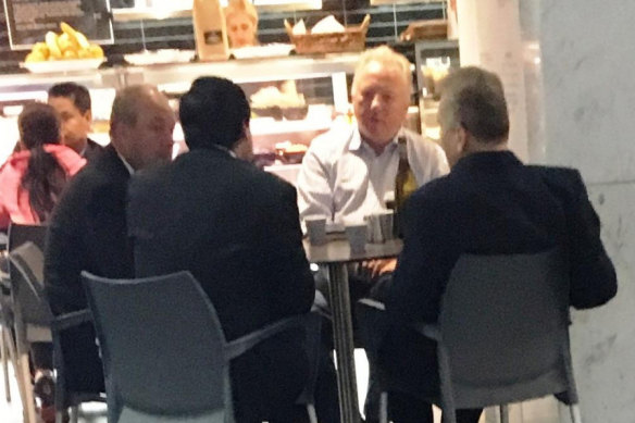 Daryl Maguire, left, with Charbel Demian, (second from left with back to camera), an unknown male (white shirt) and Michael Hawatt (right, back to camera) at a Sydney cafe.