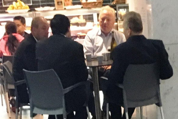 Surveillance photo of Daryl Maguire (left); with Charlie Demian (second from left with back to camera); Tim Lakos (white shirt); and Michael Hawatt (right, back to camera) at a Sydney cafe in May 2017.