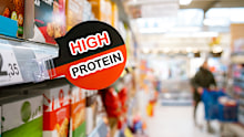 A high-protein sign in a supermarket aisle