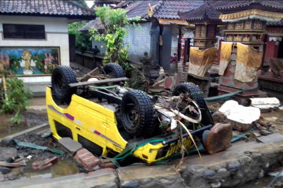 A ruined car that was rolled over after the tsunami hit Sunda Strait.
