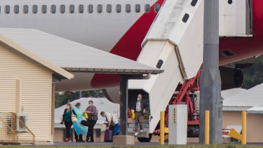 Australian evacuees from the coronavirus-struck cruise ship Diamond Princess deplane a Qantas flight from Japan at Darwin International Airport in Darwin, Thursday, February 20, 2020.