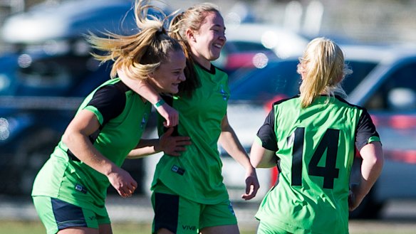 Hayley Taylor Young celebrates with her team after scoring a goal.