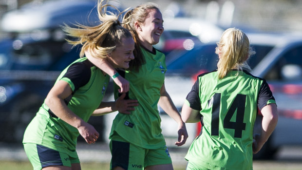 Hayley Taylor Young celebrates with her team after scoring a goal.