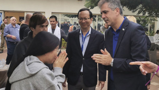 Israeli Foreign Minister Eli Cohen talks to one of the freed Thai hostages at the Shamir Medical Centre in Tel Aviv.