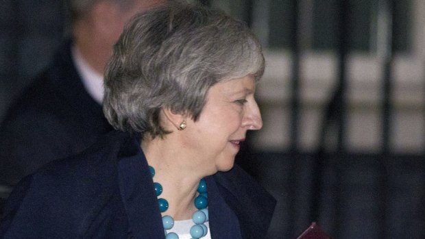 Theresa May leaves the British Parliament after deferring the Brexit vote. A 'no deal' Brexit looms larger.