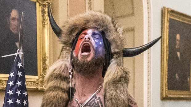US Capitol rioter ‘QAnon Shaman’ sentenced to more than three years in jail