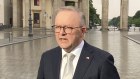 Anthony Albanese speaks to  reporters in Berlin at the Brandenburg Gate.
