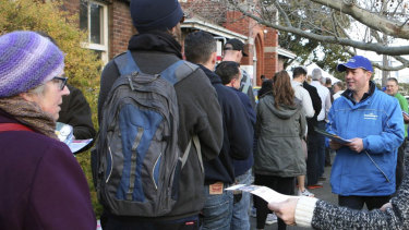 Josh Frydenberg hands out flyers to voters outside a polling station in 2016.