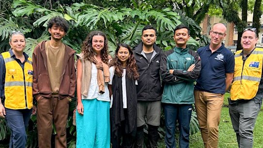 Nepalese flood survivor Cara Severino with Australian consular officials in Nepal.