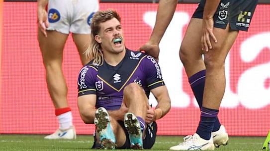 Ryan Papenhuyzen clutches his left hamstring during the Storm’s win over the Dragons.