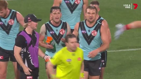 Zak Butters and other Port Adelaide players clash with the umpire on Sunday night.