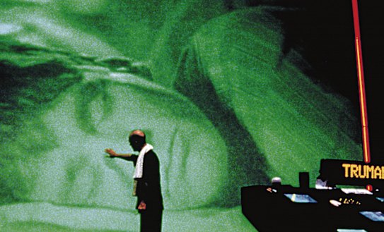 Christof (Ed Harris) watches over a sleeping Truman (Jim Carrey) in The Truman Show.