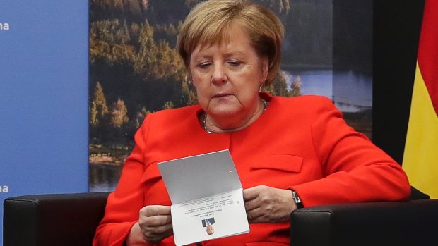 German Chancellor Angela Merkel checks her notes during a bilateral meeting with Prime Minister Scott Morrison at the G20 summit in Buenos Aires in Argentina on Saturday.