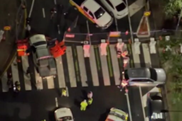 Chaos erupted at the gates of the Gold Coast 500 on Friday night after an alleged out-of-control driver ploughed into two pedestrians.