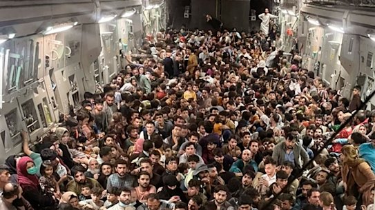 Afghan citizens pack inside a U.S. Air Force C-17 Globemaster III, as they are transported from Hamid Karzai International Airport in Afghanistan, on Aug. 15, 2021.
