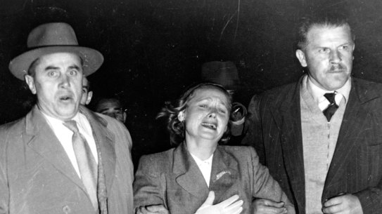 Soviet couriers escort Evdokia Petrov across the tarmac at Darwin Airport in 1954.