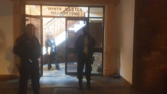 Police stationed outside White Castle Receptions, where the branch meeting took place.