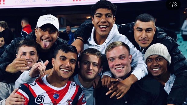 Will Penisini (white cap) and mates watching Joseph Suaalii make his NRL debut for the Sydney Roosters.