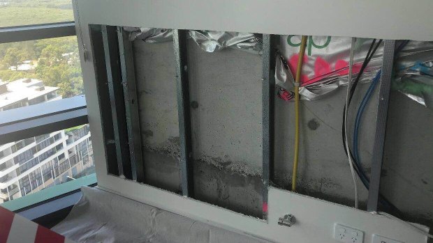 A wall that has been cut out inside an Opal Tower apartment. 
