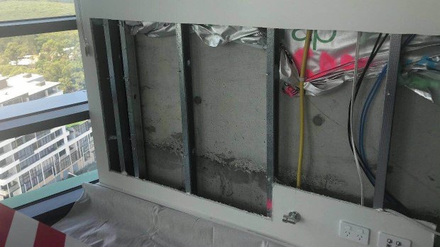A wall that has been cut out inside an Opal Tower apartment. 