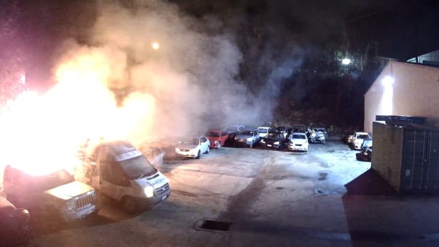 The ice-cream van burns at the Molendinar car yard. The flames soon spread to two nearby cars.