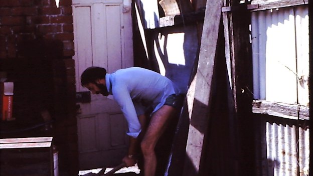 Neil Robertson fixing the outhouse at his second home in Newry Street, Fitzroy North. 