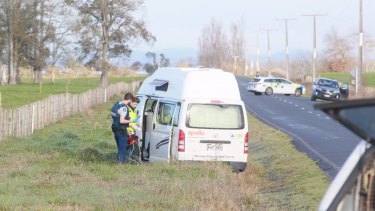 An officer and paramedic work through the open door of the campervan where the body of a man was found on Friday morning.