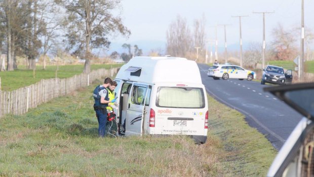 An officer and paramedic work through the open door of the campervan where the body of a man was found on Friday morning.