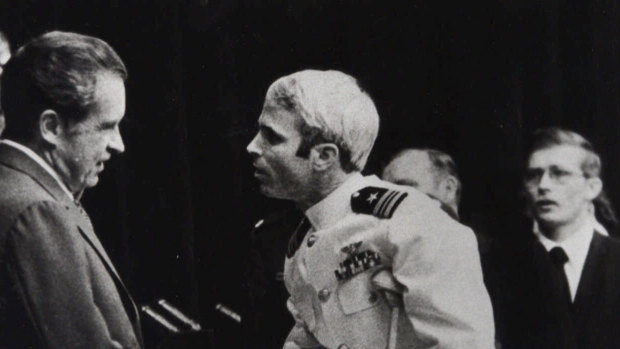 In this May 25, 1973, file photo, US Navy Lieutenant Commander John McCain is greeted by President Richard Nixon, left, in Washington, after McCain's release from a prisoner of war camp in North Vietnam. 