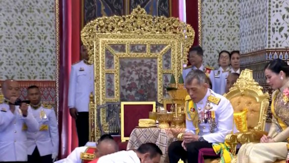 In this image made from video, Thailand’s King Maha Vajiralongkorn, centre, and Queen Suthida, right, are greeted by Thai Prime Minister Prayuth Chan-ocha, bottom front, during the second of a three-day coronation ceremony.