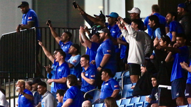 Two Blues fans celebrate their team’s famous win over Sydney University. 