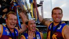 Michael Voss, Craig McCrae and Justin Leppitsch after the Lions' AFL grand final win against Collingwood in 2003. The 2020 decider is heading to Brisbane.