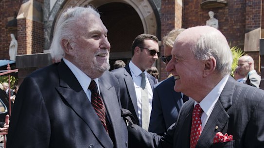 Rapprochement: One of the great feuds of Sydney has ended. John Laws and Alan Jones exchange pleasantries at the funeral of John Fordham in Paddington last November.