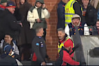 Damien Hardwick chats back to a fan after comments come his way through the crowd.