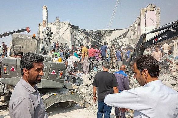 Rescue workers searched through the rubble after the school was hit by Israel-US air strikes. 