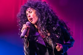 An impressively be-wigged Cher impersonator in 2023.