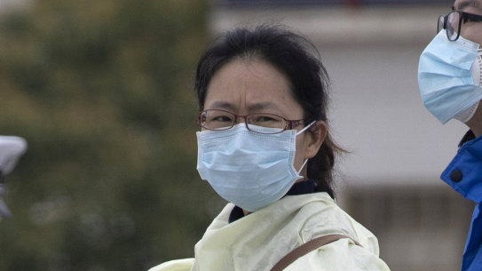 Residents of China wearing protective gear, where they are tentatively lifting restrictions. 