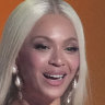 Beyonce accepts the award for album of the year with daughter Blue Ivy.